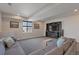 Finished basement Gathering room with sectional sofa and entertainment center at 21589 E Union Pl, Aurora, CO 80015