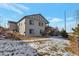 Two-story home with backyard, deck, and snowy landscaping at 21589 E Union Pl, Aurora, CO 80015