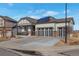 Modern ranch-style home with a three-car garage and solar panels at 21589 E Union Pl, Aurora, CO 80015