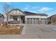 One-story home with a three-car garage and solar panels at 21589 E Union Pl, Aurora, CO 80015