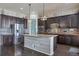 Open-concept kitchen with island and stainless steel appliances at 21589 E Union Pl, Aurora, CO 80015