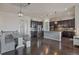 Eat-in kitchen with island and dark wood cabinets at 21589 E Union Pl, Aurora, CO 80015