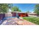 Cozy backyard featuring a patio, privacy fence, well-maintained lawn, and a charming red deck at 14157 E 26Th Ave, Aurora, CO 80011