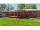 Lush backyard featuring a red wood deck, perfect for outdoor entertaining and relaxation at 14157 E 26Th Ave, Aurora, CO 80011