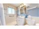 Bright bathroom featuring updated vanity, lighting, and walk-in shower at 14157 E 26Th Ave, Aurora, CO 80011
