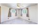 Carpeted bedroom featuring two windows, ceiling fan, and curtains at 14157 E 26Th Ave, Aurora, CO 80011