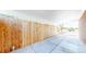 Long carport featuring a light colored concrete floor, light colored roof, and a wooden fence on one side at 14157 E 26Th Ave, Aurora, CO 80011