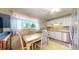 Bright kitchen with white cabinets, modern appliances, and a cozy breakfast nook with a large window at 14157 E 26Th Ave, Aurora, CO 80011