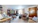 Inviting living room with ample seating, soft lighting, and a classic display cabinet at 14157 E 26Th Ave, Aurora, CO 80011