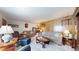 Spacious living room featuring comfortable furnishings, wood paneling, and a stylish glass coffee table at 14157 E 26Th Ave, Aurora, CO 80011