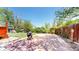 Backyard patio with brick pavers, mature trees, providing a relaxing outdoor space at 14157 E 26Th Ave, Aurora, CO 80011