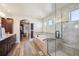 Bright bathroom boasts a soaking tub, glass shower, dual sink vanity and walk-in closet at 16611 Red Cliff Cir, Morrison, CO 80465