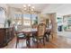 Elegant dining room with a decorative table set, hardwood flooring, and large windows at 16611 Red Cliff Cir, Morrison, CO 80465