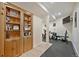Home gym area featuring built-in bookshelves, exercise equipment, and a wall-mounted television at 16611 Red Cliff Cir, Morrison, CO 80465