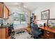 Cozy home office with a large window providing ample natural light, complemented by built-in shelves at 16611 Red Cliff Cir, Morrison, CO 80465