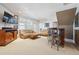 Inviting living room featuring plush seating, stylish bar with seating, and abundant natural light at 16611 Red Cliff Cir, Morrison, CO 80465