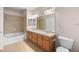 Bathroom with double sinks, bathtub, tiled shower, and ample counter space at 9397 Las Ramblas Ct # D, Parker, CO 80134