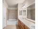 Bathroom with a bathtub, tiled shower, large mirror, and ample counter space at 9397 Las Ramblas Ct # D, Parker, CO 80134