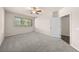Comfortable bedroom featuring plush carpet, a ceiling fan, and a large window at 9397 Las Ramblas Ct # D, Parker, CO 80134