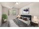 Cozy bedroom featuring a plush bed, soft lighting, and a large window offering views of the outdoors at 9397 Las Ramblas Ct # D, Parker, CO 80134