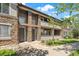 Attractive townhome exterior showcasing stone accents, private balconies, and manicured landscaping at 9397 Las Ramblas Ct # D, Parker, CO 80134
