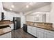 Modern kitchen with stainless steel appliances, granite countertops, and white cabinets at 9397 Las Ramblas Ct # D, Parker, CO 80134