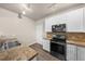 Functional kitchen featuring granite countertops, white cabinetry, and stainless steel appliances at 9397 Las Ramblas Ct # D, Parker, CO 80134