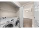 Convenient laundry room featuring a side-by-side washer and dryer at 9397 Las Ramblas Ct # D, Parker, CO 80134