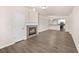 Spacious open-concept living room showcasing a fireplace, hardwood floors, and seamless flow to the kitchen at 9397 Las Ramblas Ct # D, Parker, CO 80134