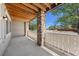 Outdoor patio area features a concrete floor, wood ceiling, stone pillars, and white railings at 9397 Las Ramblas Ct # D, Parker, CO 80134