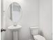 Clean powder room featuring a pedestal sink and modern toilet at 45910 Gentry Ave, Bennett, CO 80102