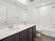 Bright bathroom with a double sink vanity and shower over tub at 45910 Gentry Ave, Bennett, CO 80102