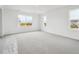 Bright bedroom featuring new carpet and scenic views from multiple windows at 45910 Gentry Ave, Bennett, CO 80102