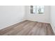 Bright bedroom featuring light wood floors and a large window at 45910 Gentry Ave, Bennett, CO 80102