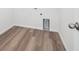 A tidy laundry room featuring wood-look flooring and ample room for machines at 45910 Gentry Ave, Bennett, CO 80102