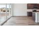 Open-concept space with sliding doors and modern kitchen appliances at 45910 Gentry Ave, Bennett, CO 80102