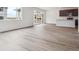 Open living space featuring sliding doors, a modern kitchen, and hardwood floors at 45910 Gentry Ave, Bennett, CO 80102