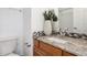 Bathroom with granite countertop, tiled backsplash, and a single sink vanity at 12035 Leyden St, Brighton, CO 80602