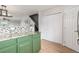 Kitchen island with granite countertop and green cabinets at 12035 Leyden St, Brighton, CO 80602