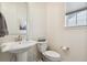 Simple and elegant powder room with pedestal sink at 9572 Taylor River Cir, Littleton, CO 80125