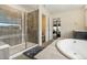 Spa-like bathroom featuring a walk-in shower and a free-standing tub at 9572 Taylor River Cir, Littleton, CO 80125