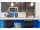 Modern kitchen with stainless steel appliances and blue accents at 9572 Taylor River Cir, Littleton, CO 80125