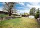 The home's large backyard features a lush lawn, wooden fence, and ample space at 3961 S Uravan St, Aurora, CO 80013