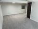 Finished basement area with neutral carpet, a closet and access to other rooms at 3961 S Uravan St, Aurora, CO 80013