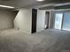 Spacious carpeted basement with ample storage and outdoor access at 3961 S Uravan St, Aurora, CO 80013