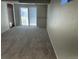 Finished basement with carpet, access to backyard, and neutral paint at 3961 S Uravan St, Aurora, CO 80013