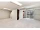 Spacious finished basement featuring carpeted floor and sliding glass doors to backyard at 3961 S Uravan St, Aurora, CO 80013