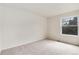 Neutral bedroom featuring a window letting in natural light and carpeted floor at 3961 S Uravan St, Aurora, CO 80013