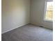 A bright bedroom with carpet, a window and neutral paint at 3961 S Uravan St, Aurora, CO 80013