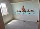 A ' bedroom featuring custom wall art and a window at 3961 S Uravan St, Aurora, CO 80013